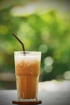 Iced coffee with coaster on the table Stock Photos