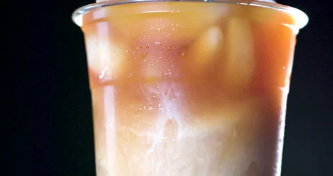 Iced Coffee with Cream Clouds in slow motion 4K Stock Footage 134843695