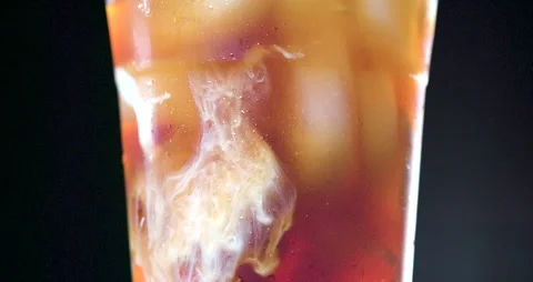 Iced Coffee with Cream Clouds in slow motion 4K Stock Footage 134844134