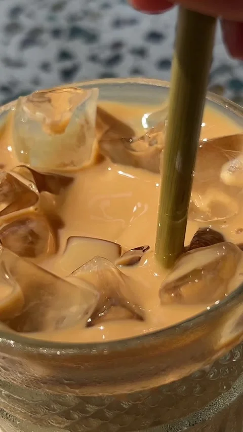 Iced coffee drink Pouring brewed coffee in a glass with ice cubes. Making iced Stock Footage 316069663