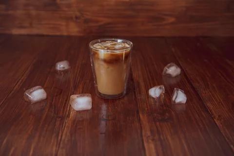 Iced coffee with ice on table Stock Photos