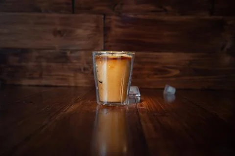 Iced coffee with ice on table Stock Photos