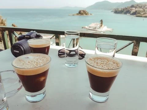Iced coffee with ocean view Stock Photos