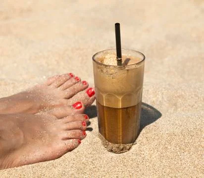Iced coffee on a sandy beach background Stock Photos