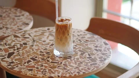 Iced coffee sits on a table in a cafe Stock Footage 341373441