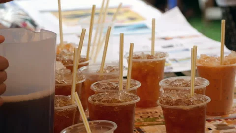 Iced coffee with straw in plastic cup ready for served Stock Footage 139355312