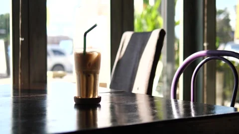 Iced Coffee on Table in Modern Café with Natural Light Stock Footage 325236837