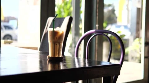 Iced Coffee on Table in Modern Café with Natural Light Video stock 325236904