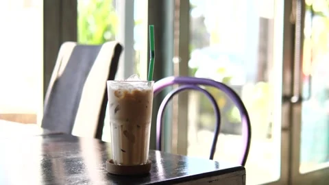 Iced Coffee on Table in Modern Café with Natural Light Video stock 325236915