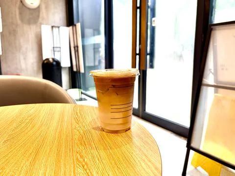 Iced Coffee on Wooden Table in Bright Modern Cafe 스톡 사진