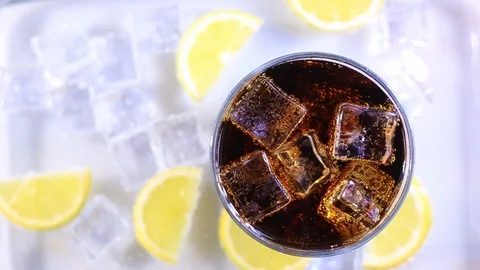 Iced cola cup and lemon slices around Stock Footage 104518390