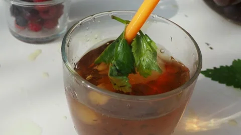 Iced fruit tea cold berry drink in clear glass mint leaf Refreshing summer drink 動画素材 168018946