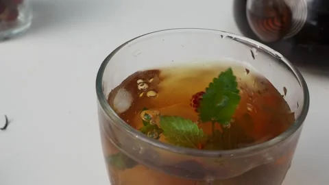 Iced fruit tea cold berry drink in clear glass mint leaf Refreshing summer drink 動画素材 168018947