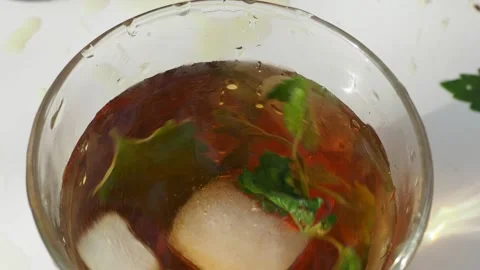 Iced fruit tea cold berry drink in clear glass mint leaf Refreshing summer drink 動画素材 168018966