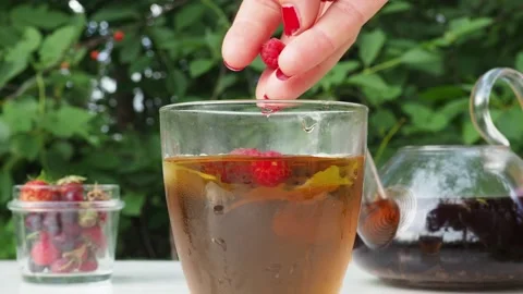 Iced fruit tea cold berry drink in clear glass mint leaf Refreshing summer drink 動画素材 168018967