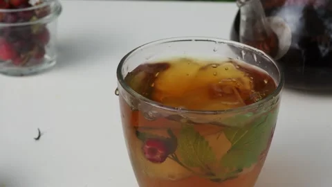 Iced fruit tea cold berry drink in clear glass mint leaf Refreshing summer drink 動画素材 168018969