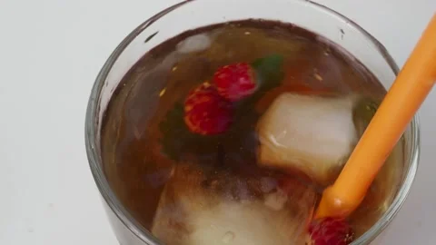 Iced fruit tea cold berry drink in clear glass mint leaf Refreshing summer drink 動画素材 168018976