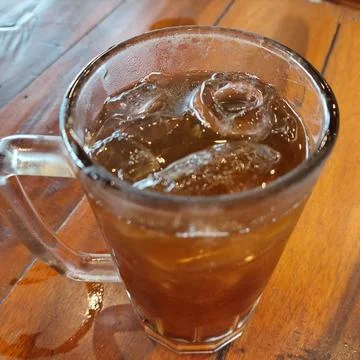 Iced lemon tea with ice cubes in a large glass Stock Photos
