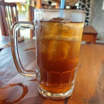 Iced lemon tea with ice cubes in a large glass Stock Photos