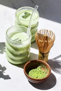 Iced Matcha Refreshment. Refreshing iced matcha drinks with a bamboo whisk and Stock Photos
