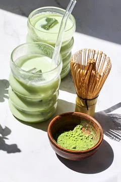 Iced Matcha Refreshment. Refreshing iced matcha drinks with a bamboo whisk and Stock Photos