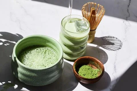 Iced Matcha Refreshment. Refreshing iced matcha drinks with a bamboo whisk and Stock Photos