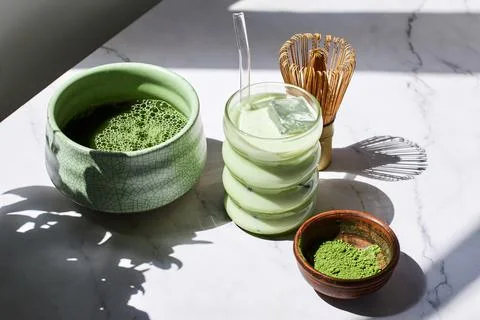 Iced Matcha Refreshment. Refreshing iced matcha drinks with a bamboo whisk and Stock Photos