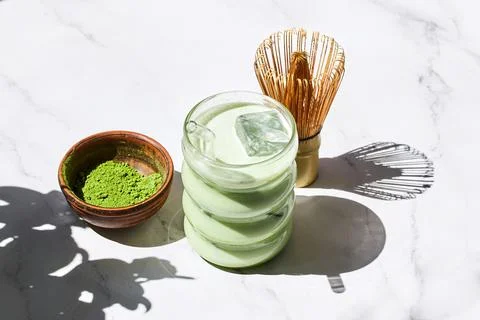Iced Matcha Refreshment. Refreshing iced matcha drinks with a bamboo whisk and Stock Photos