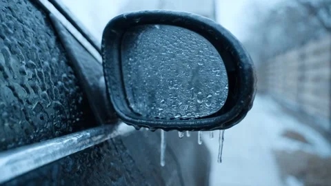 Iced-over side mirror with hanging icicles close-up Stock Footage 167781764