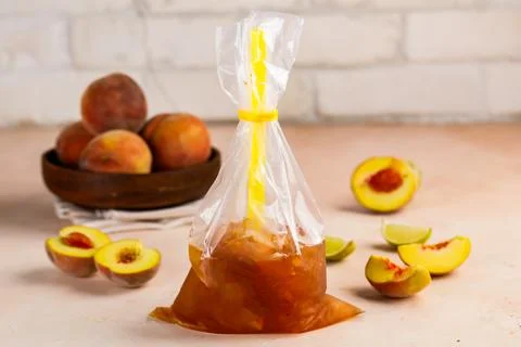 Iced Peach Bubble Tea with straw and raw fruit served in disposable pack is.. Stock Photos
