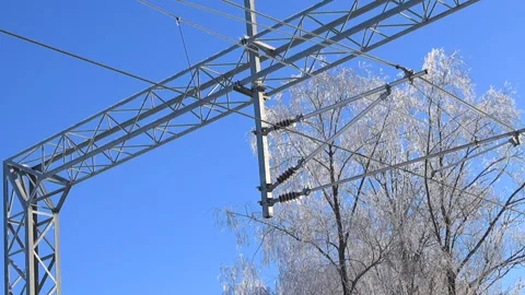 Iced Railway Catenary Insulators on Overhead Line Structure in Winter Sun Stock Footage 328912996