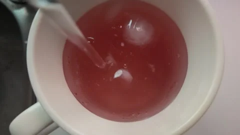 Iced Red Fruit Drink Stirred with Spoon Stock Footage 346301883