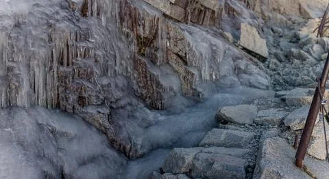 Iced steps on path from top of Mount Whitney with iron curved guardrail and.. Stock Photos