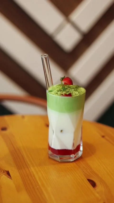 Iced Strawberry Matcha Latte: Layered Drink in Geometric Glass Stock Footage 343552627
