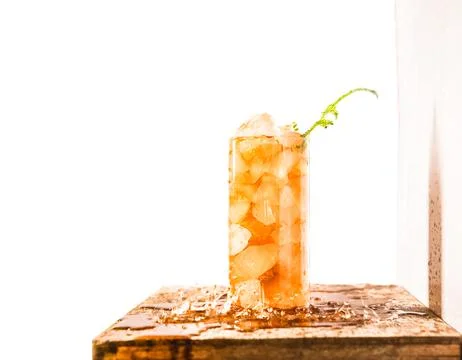 Iced tea with crashed ice in a transparent tall glass isolated over white Stock Photos
