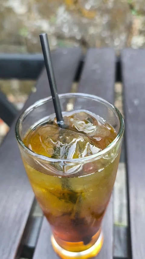 Iced Tea with Ice on Wooden Table Stock Footage 344913991