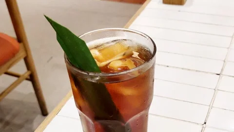 Iced tea infused with a pandan leaf Video stock 279996257