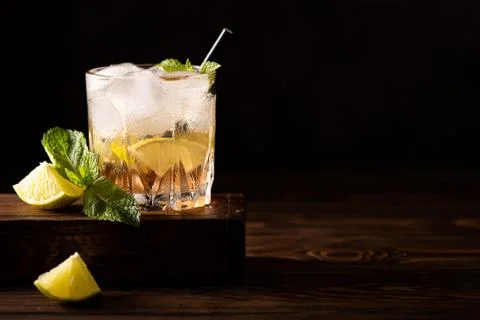 Iced tea with mint, lime slices and strawberry syrup Stock Photos