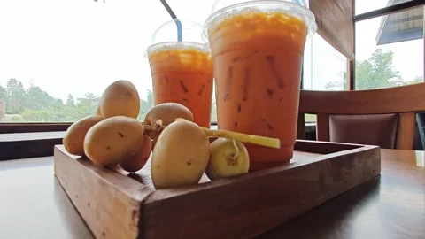 Iced Thai Milk Tea Drinks with Fresh Dates on Wooden Tray. Stock Footage 340486879