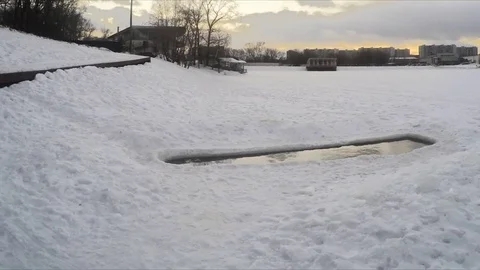 Icehole on the pond in winter evening timelapse Video stock 79814191
