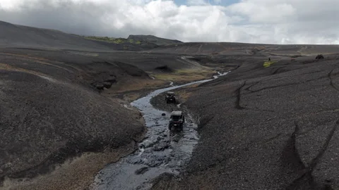 Iceland - 15 August 2025 UTV vehicle Driving Through River in Volcanic Canyon Stock Footage 321304731