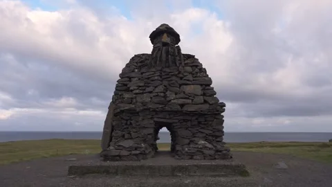 Iceland Arnarstapi Rock Sculpture Troll. Camera Tilts Up to Tall Rocks Stock Footage 258488132