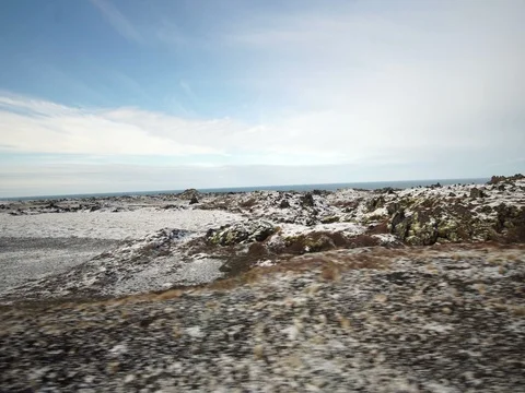 Iceland road trip view from side way. Meadow with snow cover and nothing around Stock Footage 75125143