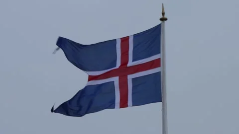 Icelandic Flag Waving in the Wind Against a Cloudy Sky 動画素材 305873302