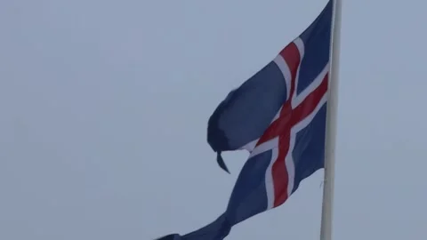 Icelandic Flag Waving in the Wind Against a Cloudy Sky Stock Footage 305873699
