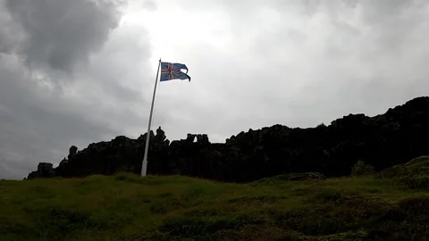 Icelandic flag waving in the wind at Thingvellir National Park, 4K Stock Footage 334954415