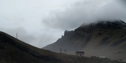 Icelandic house in mountainside with clouds Stock Footage 122918097