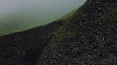 Icelandic Volcanic Landscape with Columnar Basalt and Misty Valley Stock Footage 341295075