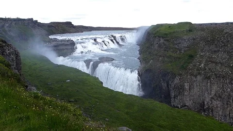 Icelandic waterfall revealed by panning camera. Video stock 73609367