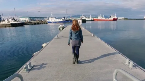 Icelandic Woman Walking thru Harbor Stock Footage 83105853
